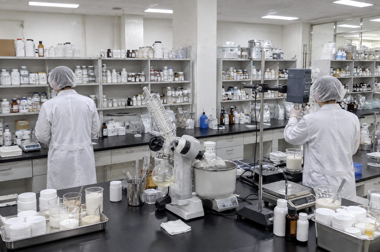 Two formulators developing a cream and a serum in the KoreanOEM lab