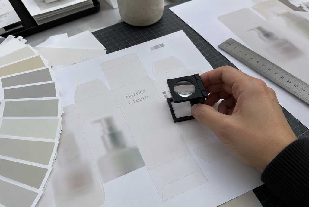 Checking a carton proof with a loupe